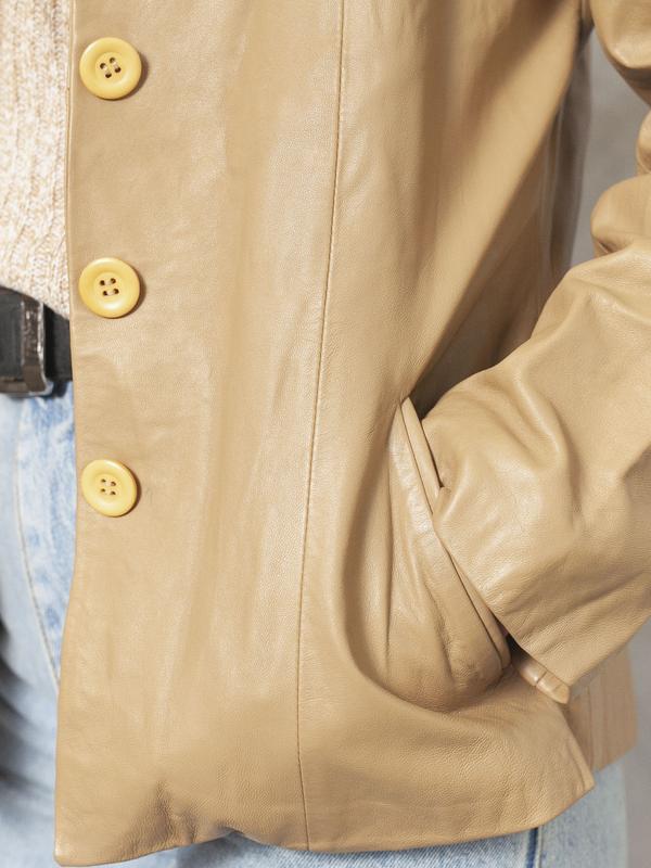 Model is wearing vintage 90's minimalist leather jacket in beige colour for women